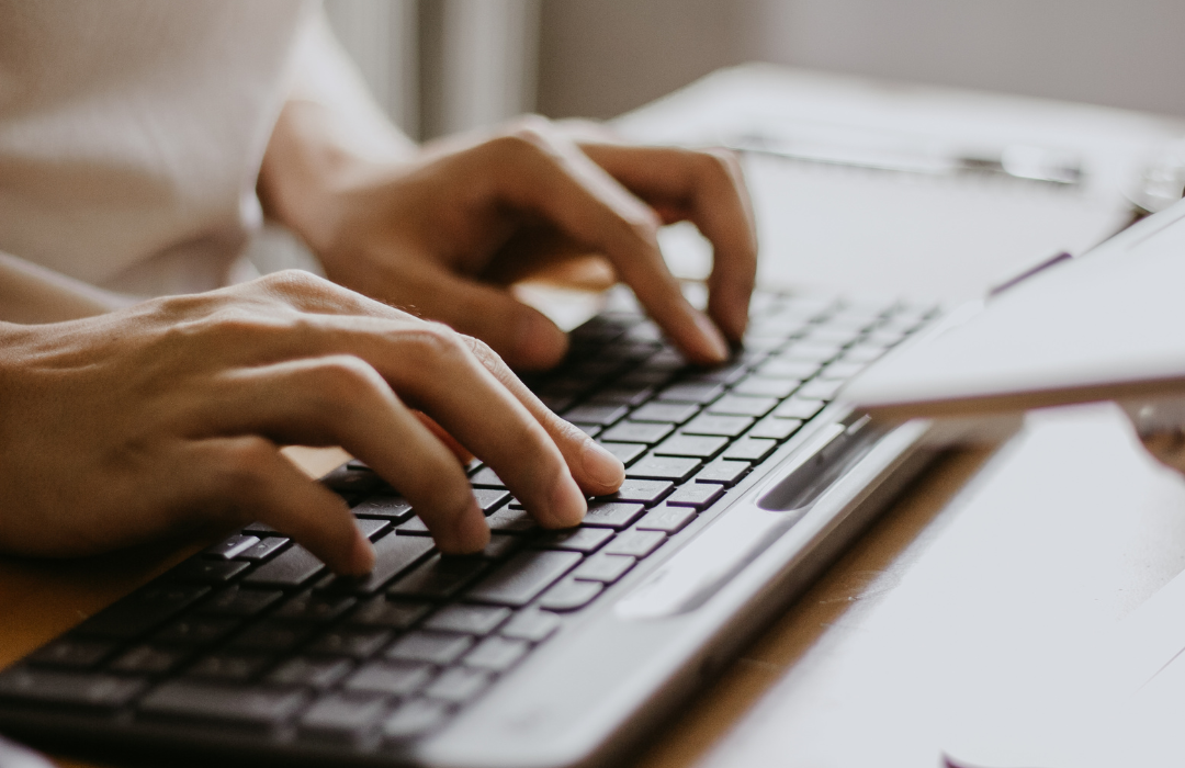 Person using computer with hand